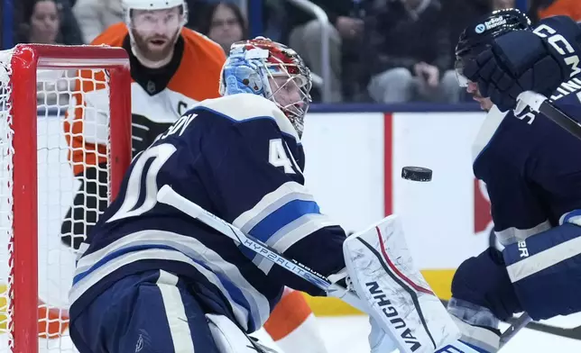 Columbus Blue Jackets goaltender Daniil Tarasov (40) blocks a shot in the first period of an NHL hockey game against the Philadelphia Flyers Tuesday, Jan. 14, 2025, in Columbus, Ohio. (AP Photo/Sue Ogrocki)