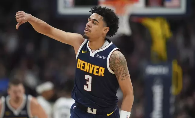 Denver Nuggets guard Julian Strawther gestures after hitting a three-point basket against the Brooklyn Nets in the first half of an NBA basketball game Friday, Jan. 10, 2025, in Denver. (AP Photo/David Zalubowski)