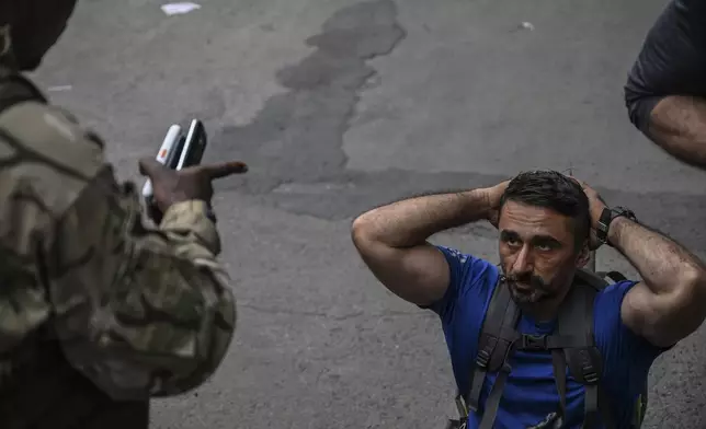 M23 rebels escort Romanian mercenaries to the border crossing into Rwanda in Goma, Democratic Republic of Congo, Wednesday, Jan. 29, 2025.(AP Photo/Moses Sawasawa)