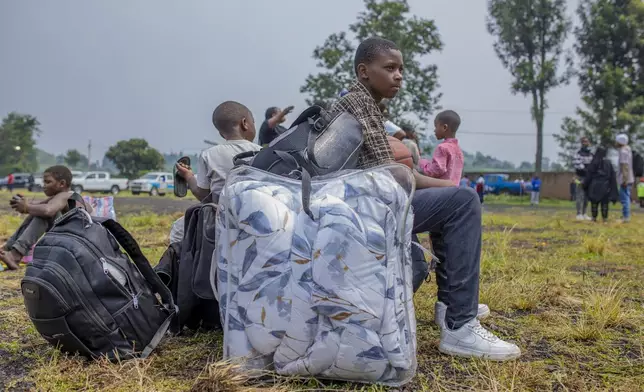 People who crossed from Congo wait for assistance in Gyseny, Rwanda, Tuesday, Jan. 28, 2025, following M23 rebels' advances into eastern Congo's capital Goma. (AP Photo/Yuhi Irakiza)