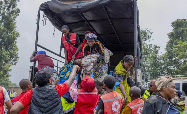 People who crossed from Congo disembark a truck in Gyseny, Rwanda, Tuesday, Jan. 28, 2025, following M23 rebels' advances into eastern Congo's capital Goma. (AP Photo/Yuhi Irakiza)