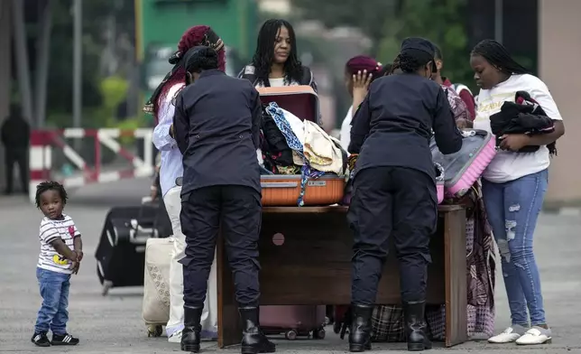 Rwanda security officials check people crossing from Congo in Gisenyi, Rwanda, Wednesday, Jan. 29, 2025, following M23 rebels' advances into eastern Congo's capital Goma. (AP Photo/Brian Inganga)