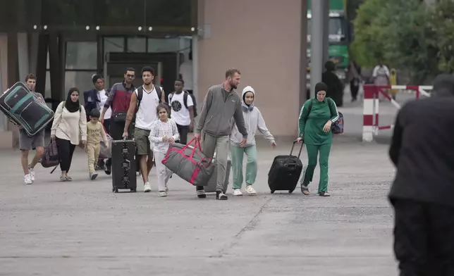 Rwanda security officials check people crossing from Congo in Gisenyi, Rwanda Rwanda, Wednesday, Jan. 29, 2025, following M23 rebels' advances into eastern Congo's capital Goma. (AP Photo/Brian Inganga)