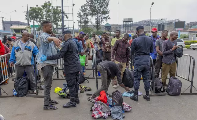 Rwanda security officials check people crossing from Congo in Gyseny, Rwanda, Tuesday, Jan. 28, 2025, following M23 rebels' advances into eastern Congo's capital Goma. (AP Photo/Yuhi Irakiza)