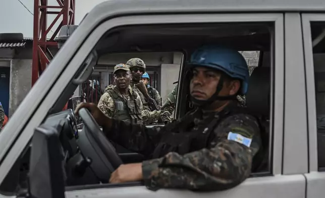 M23 rebels look at a UN peace-keepers vehicle in Goma, Democratic Republic of Congo, Wednesday, Jan. 29, 2025.(AP Photo/Moses Sawasawa)