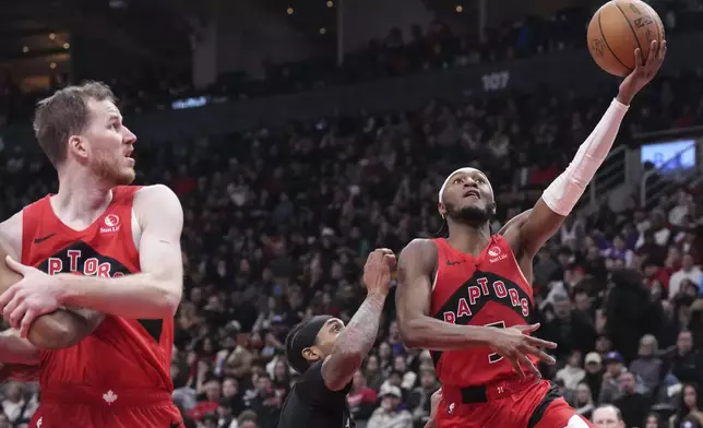 Toronto Raptors' Immanuel Quickley (5) shoots against the Brooklyn Nets during the first half of an NBA basketball game in Toronto on Wednesday, Jan. 1, 2025. (Chris Young/The Canadian Press via AP)