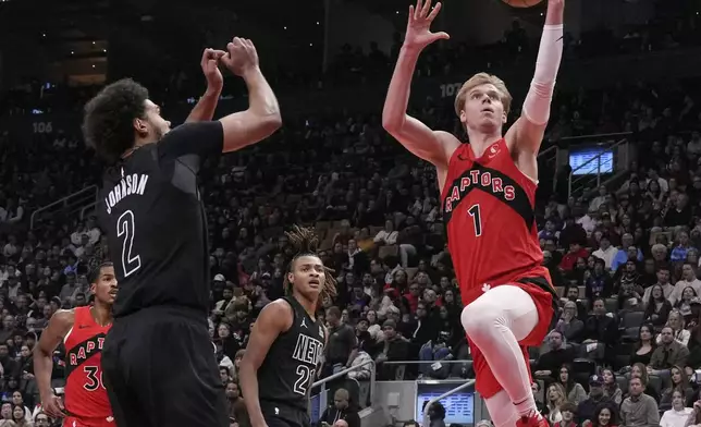 Toronto Raptors' Gradey Dick (1) scores against the Brooklyn Nets during the first half of an NBA basketball game in Toronto on Wednesday, Jan. 1, 2025. (Chris Young/The Canadian Press via AP)