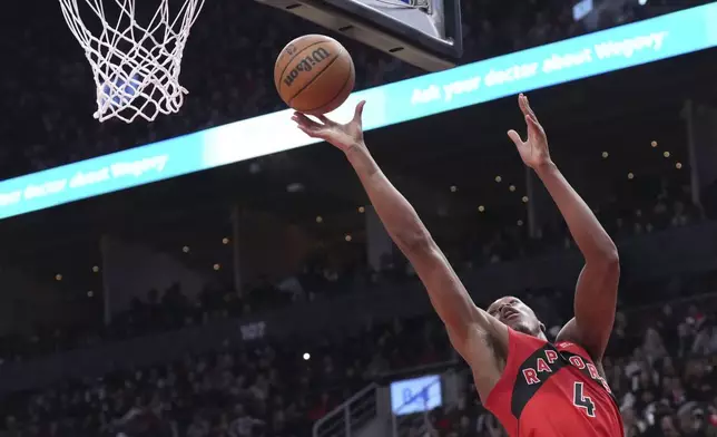 Toronto Raptors' Scottie Barnes scores against the Brooklyn Nets during the first half of an NBA basketball game in Toronto on Wednesday, Jan. 1, 2025. (Chris Young/The Canadian Press via AP)