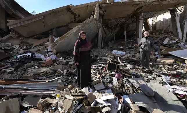 FILE - Mariam Kourani, 56, and her husband Ali Haidous, stand in the rubble of their destroyed house after they returned to their village of Hanouiyeh, southern Lebanon, Nov. 28, 2024, following a ceasefire between Israel and Hezbollah that went into effect the day before. (AP Photo/Hussein Malla, File)