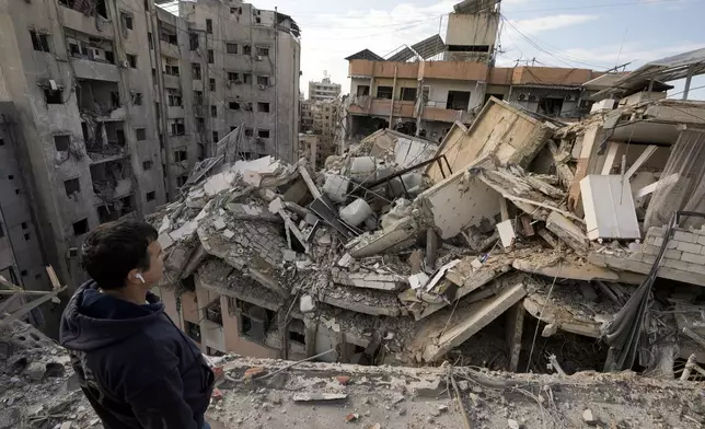 FILE - A man pauses as he looks at destroyed buildings in Dahiyeh, Beirut, Lebanon, Nov. 29, 2024. (AP Photo/Bilal Hussein, File)