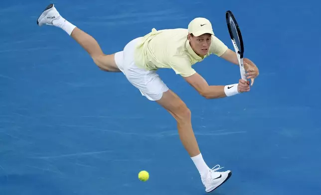 Jannik Sinner of Italy plays a backhand return to Ben Shelton of the U.S. during their semifinal match at the Australian Open tennis championship in Melbourne, Australia, Friday, Jan. 24, 2025. (AP Photo/Manish Swarup)