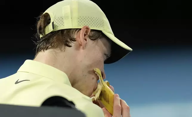 Jannik Sinner of Italy eats a banana during the men's singles final against Alexander Zverev of Germany at the Australian Open tennis championship in Melbourne, Australia, Sunday, Jan. 26, 2025. (AP Photo/Ng Han Guan)
