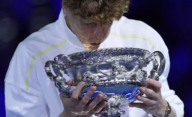 Jannik Sinner of Italy looks into the Norman Brookes Challenge Cup after defeating Alexander Zverev of Germany in the men's singles final at the Australian Open tennis championship in Melbourne, Australia, Sunday, Jan. 26, 2025. (AP Photo/Ng Han Guan)