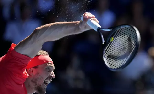 Alexander Zverev of Germany serves to Novak Djokovic of Serbia during their semifinal match at the Australian Open tennis championship in Melbourne, Australia, Friday, Jan. 24, 2025. (AP Photo/Ng Han Guan)