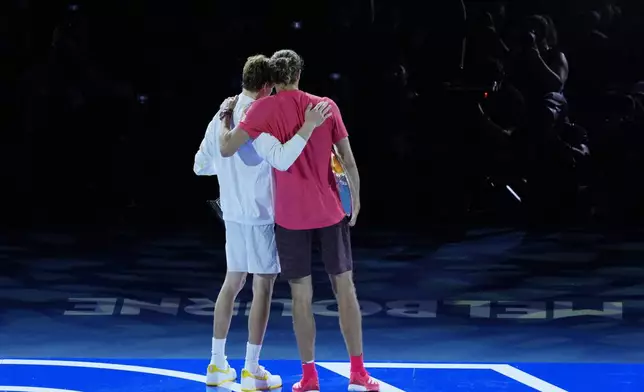 Jannik Sinner of Italy, left, is congratulated by Alexander Zverev of Germany following the men's singles final at the Australian Open tennis championship in Melbourne, Australia, Sunday, Jan. 26, 2025. (AP Photo/Vincent Thian)