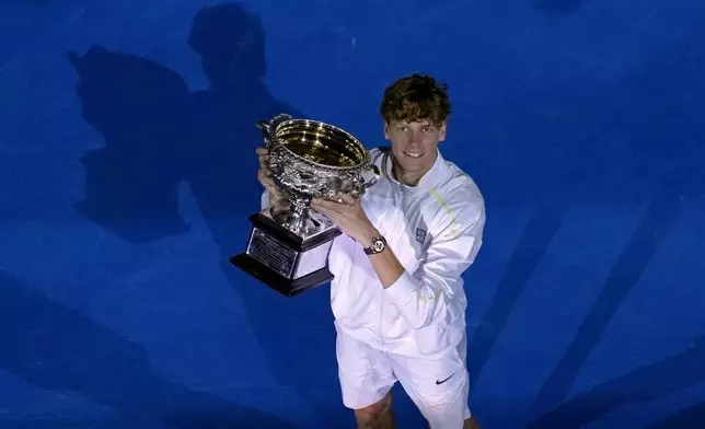 Jannik Sinner of Italy holds the Norman Brookes Challenge Cup after defeating Alexander Zverev of Germany in the men's singles final at the Australian Open tennis championship in Melbourne, Australia, Sunday, Jan. 26, 2025. (AP Photo/Manish Swarup)
