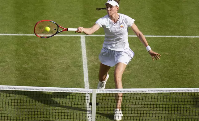 FILE - Elena Rybakina of Kazakhstan plays a forehand return to Barbora Krejcikova of the Czech Republic during their semifinal match at the Wimbledon tennis championships in London, Thursday, July 11, 2024. (AP Photo/Kirsty Wigglesworth, File)