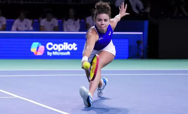 FILE - Italy's Jasmine Paolini returns the ball to Slovakia's Rebecca Sramkova during the Billie Jean King Cup final at the Martin Carpena Sports Hall in Malaga, southern Spain, on Wednesday, Nov. 20, 2024. (AP Photo/Manu Fernandez, File)