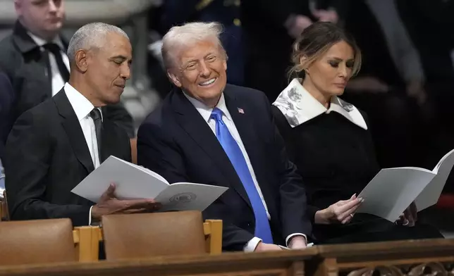 Former President Barack Obama talks with President-elect Donald Trump, next to Melania Trump, as they arrive to attend the state funeral for former President Jimmy Carter at Washington National Cathedral in Washington, Thursday, Jan. 9, 2025. (AP Photo/Ben Curtis)