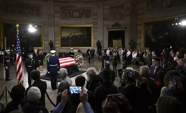 President elect Donald Trump and his wife Melania Trump visit the flag draped casket of the late former President Jimmy Carter as he lies in state at the Rotunda of the U.S. Capitol on Wednesday, Jan. 8, 2025, in Washington. (AP Photo/John McDonnell)