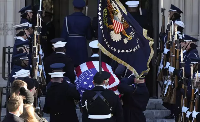 The flag-draped casket of former President Jimmy Carter arrives at Washington National Cathedral in Washington, Thursday, Jan. 9, 2025, for a State Funeral. (AP Photo/Mark Schiefelbein)