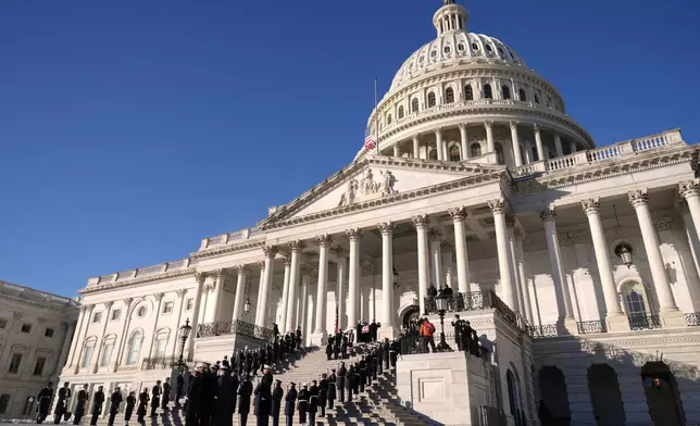 A joint services body bearer team carries the flag-draped casket of former President Jimmy Carter from the U.S. Capitol in Washington, Thursday, Jan. 9, 2025, to head to Washington National Cathedral for a State Funeral. (AP Photo/Susan Walsh, Pool)