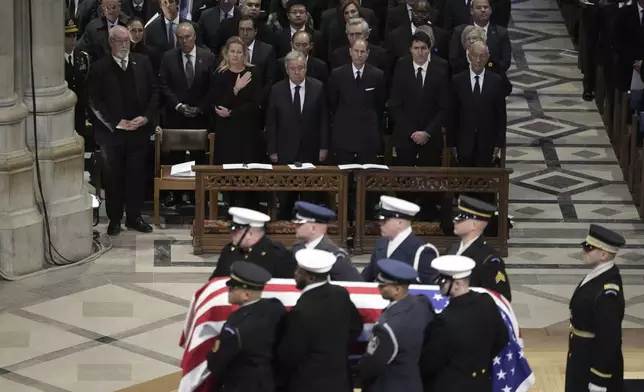 The flag-draped casket of former President Jimmy Carter departs after a state funeral at Washington National Cathedral in Washington, Thursday, Jan. 9, 2025. (AP Photo/Ben Curtis)