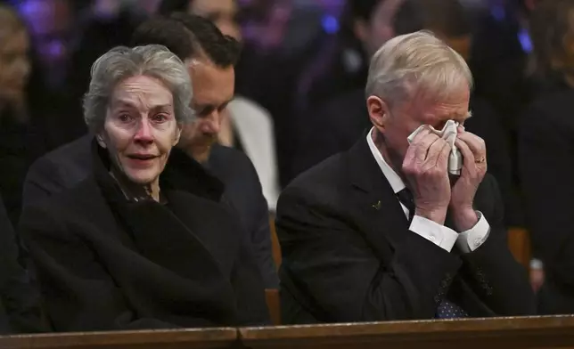 Jack Carter, right, and his wife Liz react during the state funeral of former President Jimmy Carter at the National Cathedral, Thursday, Jan. 9, 2025, in Washington. (Ricky Carioti/The Washington Post via AP, Pool)