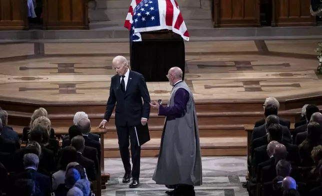 President Joe Biden walks to his seat after delivering remarks at the state funeral of former President Jimmy Carter at the National Cathedral, Thursday, Jan. 9, 2025, in Washington. (Haiyun Jiang/The New York Times via AP, Pool)