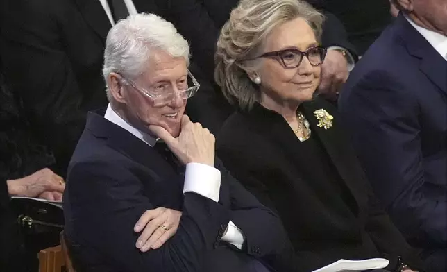 Former President Bill Clinton and former Secretary of State Hillary Clinton listen during the state funeral for former President Jimmy Carter at Washington National Cathedral in Washington, Thursday, Jan. 9, 2025. (AP Photo/Jacquelyn Martin)