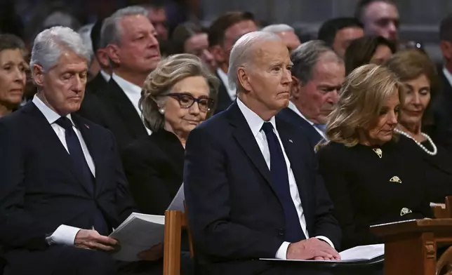 Marilyn Quayle, from third row left, former Vice President Al Gore, from second row left, former President Bill Clinton, former Secretary of State Hillary Clinton, former President George W. Bush and his wife former first lady Laura Bush, and from front row left, President Joe Biden and first lady Jill Biden listen during a state funeral for former President Jimmy Carter at the National Cathedral, Thursday, Jan. 9, 2025, in Washington. Looking on in background at seco(Ricky Carioti/The Washington Post via AP, Pool)