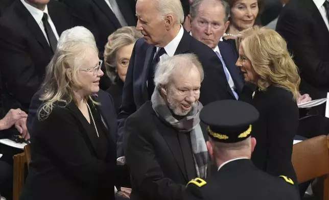 President Joe Biden and first lady Jill Biden greet Amy Carter and Jeff Carter before the state funeral for former President Jimmy Carter at Washington National Cathedral in Washington, Thursday, Jan. 9, 2025. (AP Photo/Jacquelyn Martin)