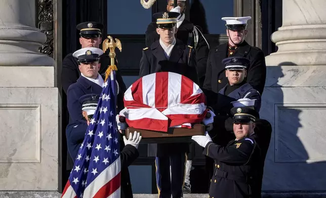 The flag-draped casket of former President Jimmy Carter is carried from the U.S. Capitol on the way to a state funeral at the National Cathedral, in Washington, Thursday, Jan. 9, 2025. (AP Photo/J. Scott Applewhite)