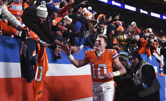 Denver Broncos quarterback Bo Nix greets fans after an NFL football game against the Kansas City Chiefs, Sunday, Jan. 5, 2025, in Denver. (AP Photo/Geneva Heffernan)