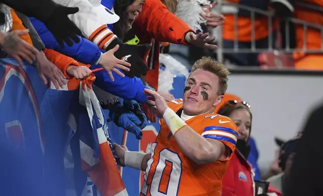 fans congratulate Denver Broncos quarterback Bo Nix after an NFL football game against the Kansas City Chiefs, Sunday, Jan. 5, 2025, in Denver. (AP Photo/David Zalubowski)