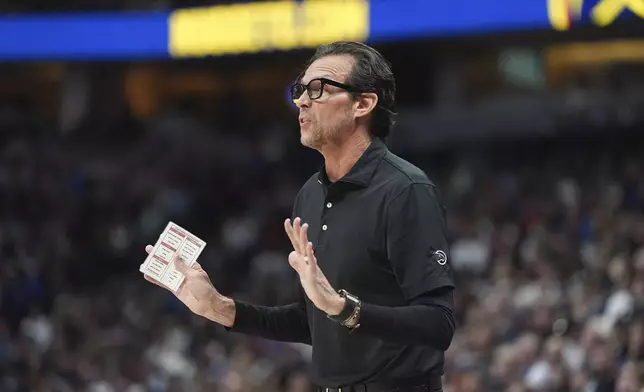 Atlanta Hawks head coach Quin Snyder directs his team against the Denver Nuggets in the first half of an NBA basketball game Wednesday, Jan. 1, 2025, in Denver. (AP Photo/David Zalubowski)