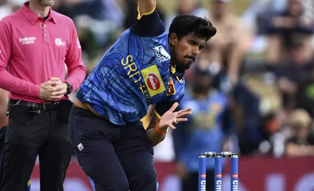 Sri Lanka's Maheesh Theekshana bowls to New Zealand during their one day international cricket match in Hamilton, New Zealand. Wednesday, Jan. 8, 2025. (Andrew Cornaga/Photosport via AP)