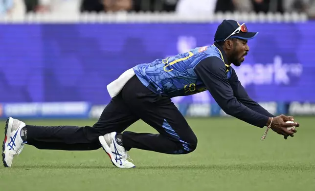 Sri Lanka'a Kamindu Mendis takes a catch to dismiss New Zealand's Nathan Smith during their one day international cricket match in Hamilton, New Zealand. Wednesday, Jan. 8, 2025. (Andrew Cornaga/Photosport via AP)