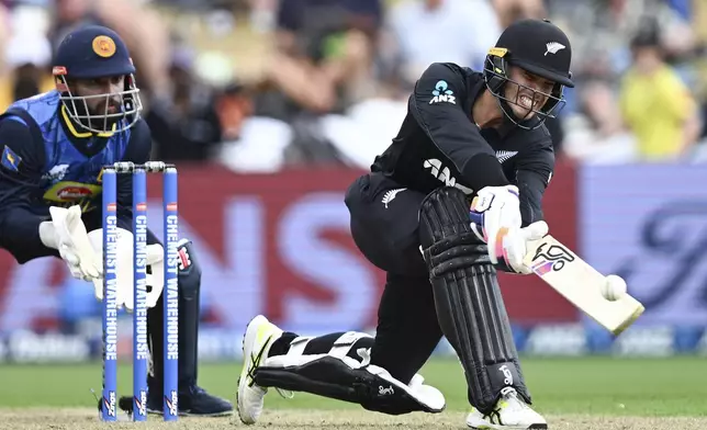 New Zealand's Mark Chapman, right, bats in front of Sri Lanka's Kusal Mendis during their one day international cricket match in Hamilton, New Zealand. Wednesday, Jan. 8, 2025. (Andrew Cornaga/Photosport via AP)