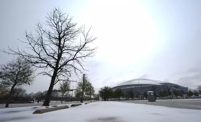 Snow is accumulated on a parking lot near AT&amp;T Stadium a day prior to the Cotton Bowl NCAA College Football Playoff semifinal game between Ohio State and Texas, Thursday, Jan. 9, 2025, in Arlington, Texas. (AP Photo/Julio Cortez)