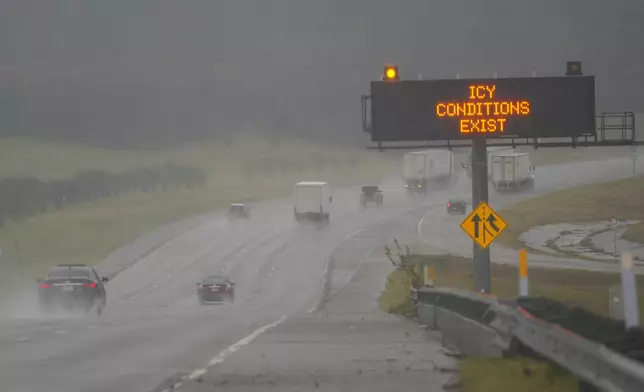 A sign warns motorists of icy conditions along Interstate-20 during a winter storm, Thursday, Jan. 9, 2025, in Grand Prairie, Texas. (AP Photo/Julio Cortez)