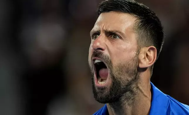 Novak Djokovic of Serbia reacts after winning a point against Tomas Machac of the Czech Republic during their third round match at the Australian Open tennis championship in Melbourne, Australia, Friday, Jan. 17, 2025. (AP Photo/Asanka Brendon Ratnayake)