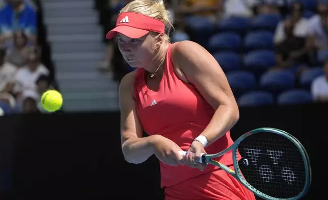 Clara Tauson of Denmark plays a backhand return to Aryna Sabalenka of Belarus during their third round match at the Australian Open tennis championship in Melbourne, Australia, Friday, Jan. 17, 2025. (AP Photo/Asanka Brendon Ratnayake)