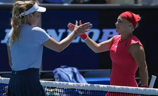 Diana Shnaider, right, of Russia congratulates Donna Vekic of Croatia following their third round match at the Australian Open tennis championship in Melbourne, Australia, Friday, Jan. 17, 2025. (AP Photo/Vincent Thian)