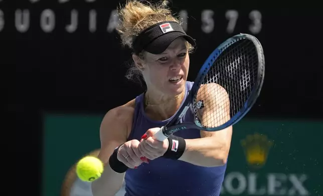 Laura Siegemund of Germany plays a backhand return to Anastasia Pavlyuchenkova of Russia during their third round match at the Australian Open tennis championship in Melbourne, Australia, Friday, Jan. 17, 2025. (AP Photo/Manish Swarup)