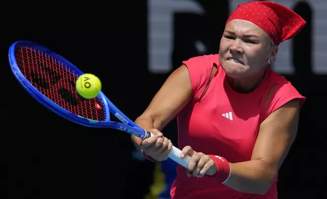 Diana Shnaider of Russia plays a backhand return to Donna Vekic of Croatia during their third round match at the Australian Open tennis championship in Melbourne, Australia, Friday, Jan. 17, 2025. (AP Photo/Vincent Thian)