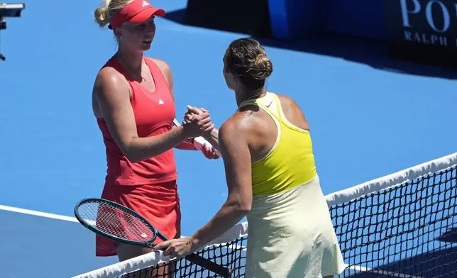 Aryna Sabalenka, right, of Belarus is congratulated by Clara Tauson of Denmark following their third round match at the Australian Open tennis championship in Melbourne, Australia, Friday, Jan. 17, 2025. (AP Photo/Asanka Brendon Ratnayake)