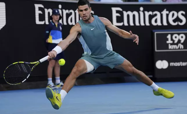 Carlos Alcaraz of Spain plays a forehand return to Alexander Shevchenko of Kazakhstan during their first round match at the Australian Open tennis championship in Melbourne, Australia, Monday, Jan. 13, 2025. (AP Photo/Vincent Thian)