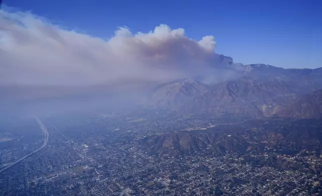 A plume of smoke from a wildfire forms over the city's basin Thursday, Jan. 9, 2025 in Los Angeles. (AP Photo/Mark J. Terrill)