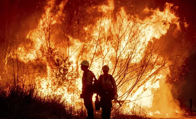 Fire crews battle the Kenneth Fire in the West Hills section of Los Angeles, Thursday, Jan. 9, 2025. (AP Photo/Ethan Swope)